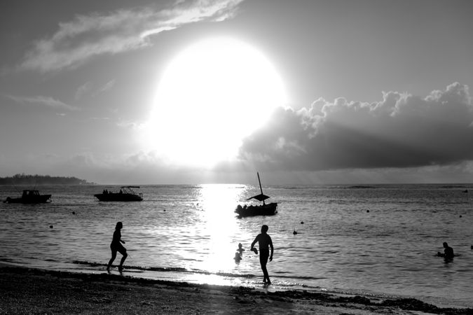 Silhouettes of people on tropical beach
