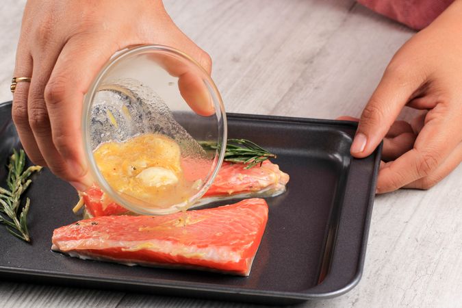 Cooking Processs, Add Melted Butter and Garlic to Raw Salmon with Rosemary.