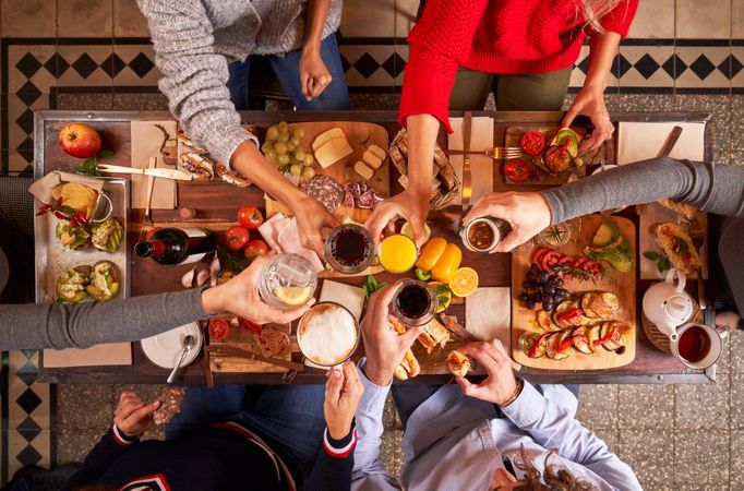 Anonymous people clinking glasses during dinner