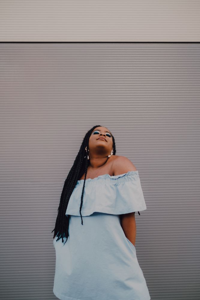 Content trendy Black woman on wall