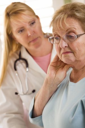 Older Adult Woman Being Consoled by Female Doctor or Nurse