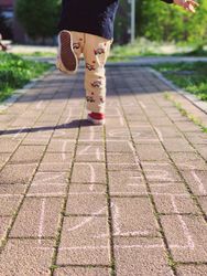 Boy running on sidewalk