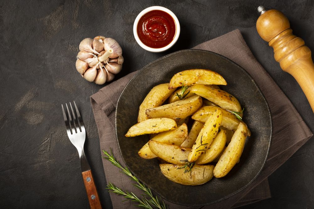 Roasted potatoes with rosemary on the plate.