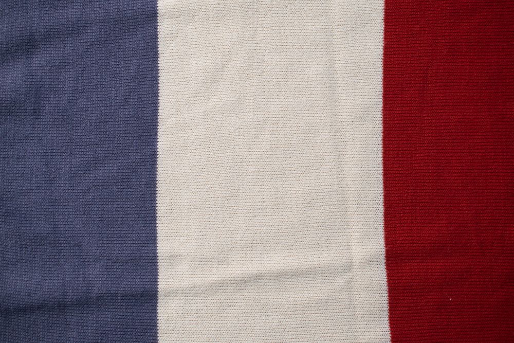 Triple color grey milk and red on knitted fabric background texture.