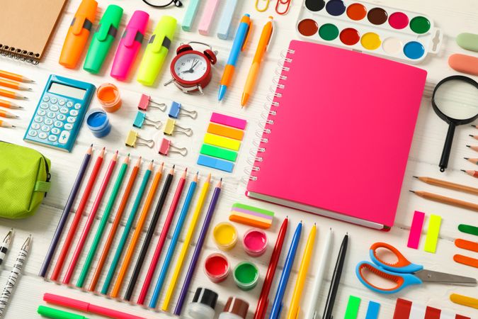 Flat lay composition with school supplies on wooden background