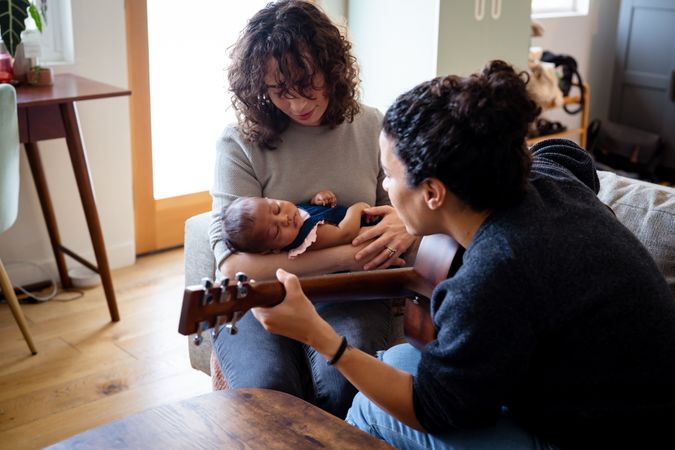 Female playing lullaby for baby and wife