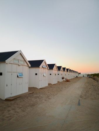 Wooden cottages under calm blue sky