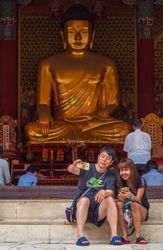 Seoul, South Korea - August, 08 2017: Asian couple taking selfie near Buddhist shrine