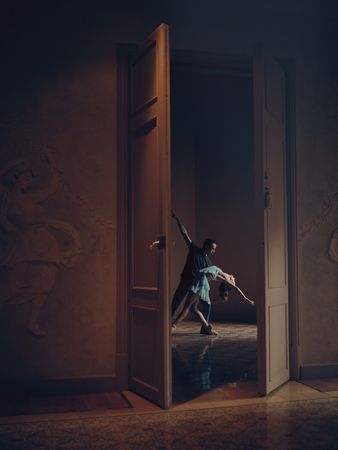 Anonymous female and partner dancing in empty room