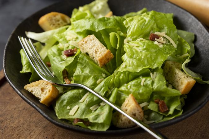 Caesar salad with croutons and bacon.