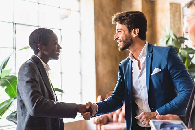 Two colleagues shaking hands in the office