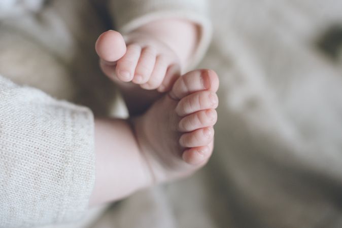 Charming cute baby feet and fingers of new born