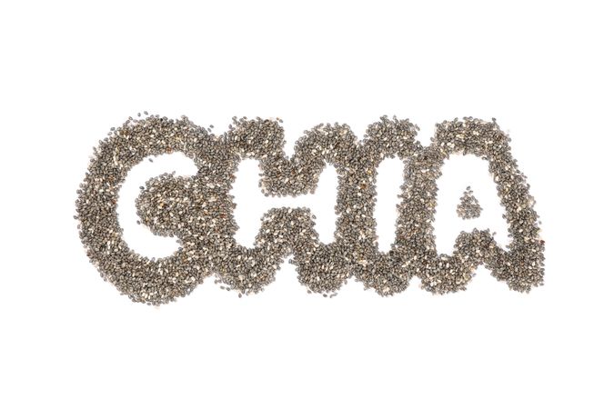 Word Chia layout of chia seeds, isolated on plain background
