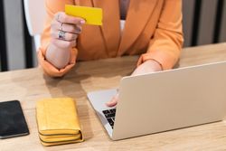 Happy woman making payment during online shopping