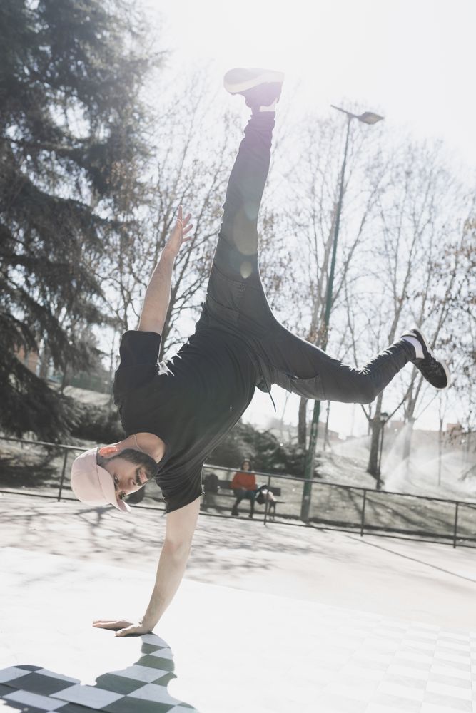 Man dancing break dance in park