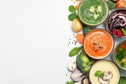 Colorful soups arranged on right of picture with copy space