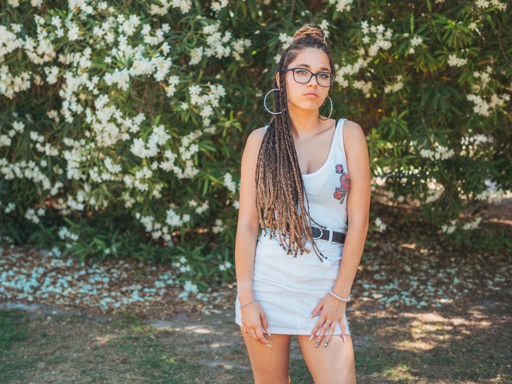 young female standing near blooming trees