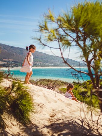 small girls having a stroll at beach
