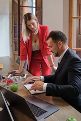 Smiling female manager working on project with male colleague