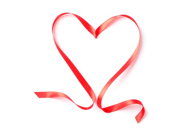 Red ribbon heart isolated on blank background