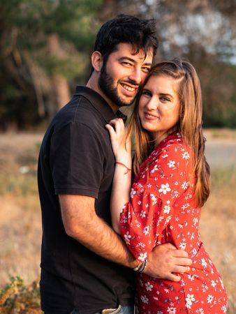 Young happy couple embracing in beautiful garden