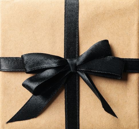 Gift box with dark bow, close up