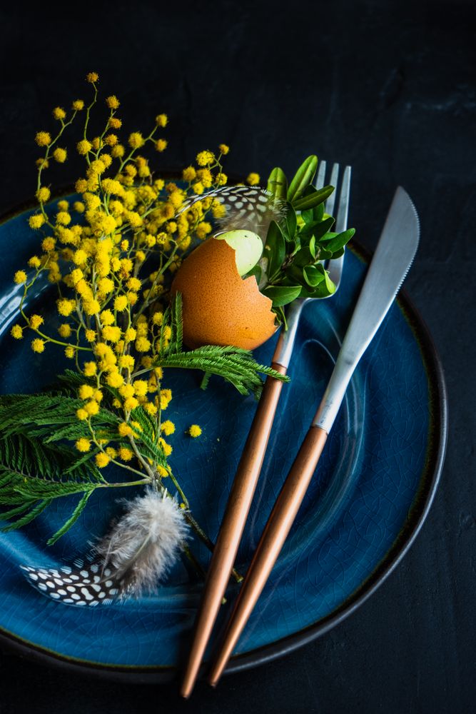 Rustic table setting with decorate spring foliage on navy plate