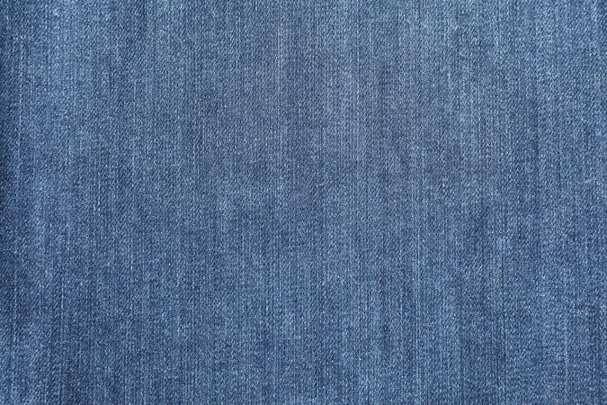 Texture of blue jeans as background, space for text