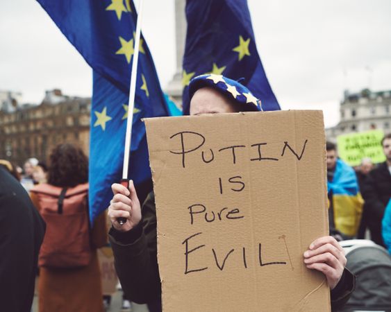 London, England, United Kingdom - March 5 2022: Woman with EU flag and anti Putin sign