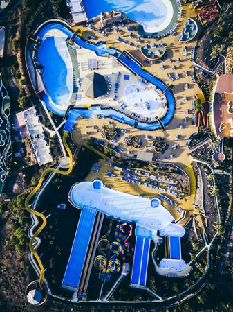 Aerial shot of a blue and yellow resort with water slides