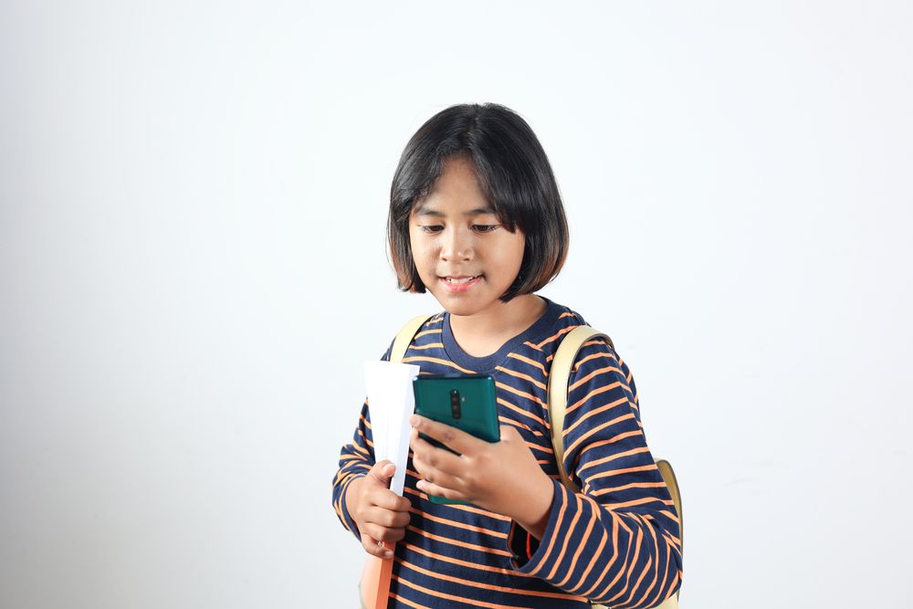 Asian School Girl Holding Mobile Phone