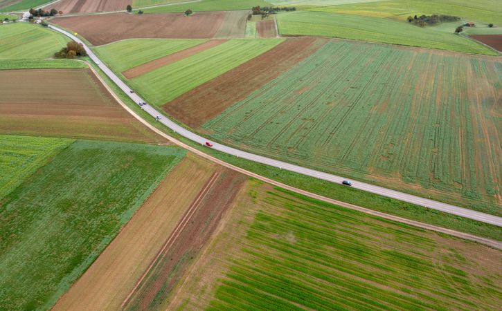 Drone shot of a winding road through agricultural fields in Stuttgart, Germany