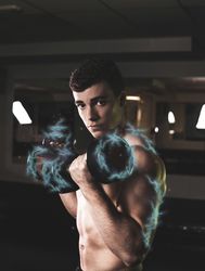 Powerful man exercising with dumbbells