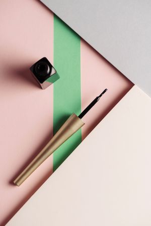 Liquid eyeliner brush on geometric background