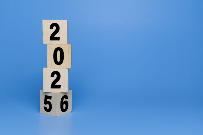 flip wooden blocks with year 2025 to 2026 isolated on blue background