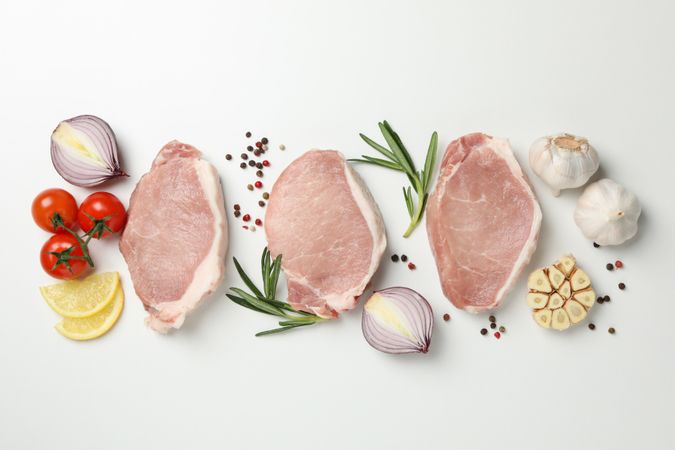 Composition with raw meat and ingredients on light background, top view