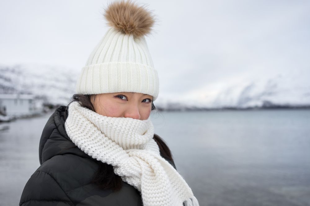 Joyful young woman in warm clothes