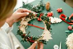 Woman holding Christmas wreath in hands