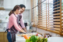 Couple washing dishes and cleaning in the kitchen