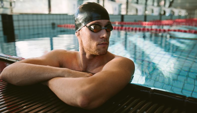 Professional male swimmer taking a break after a swim