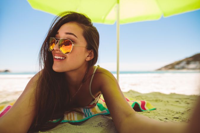 Smiling young woman on vacation at a beach on a sunny day