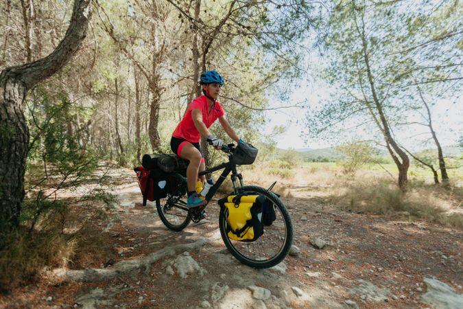 Woman riding bicycle in forest