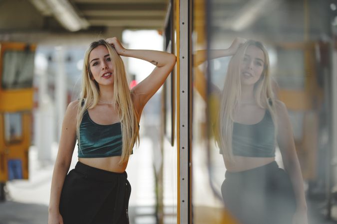 Cheerful blonde woman standing on train cabin