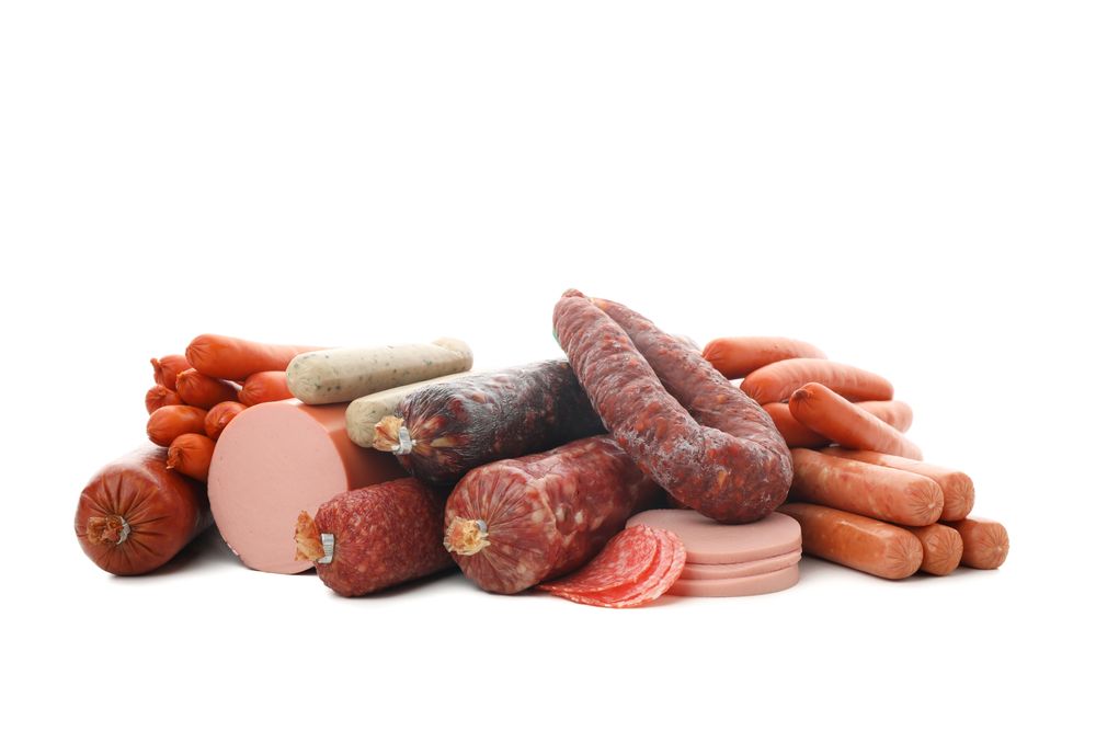 Large variety of cured meats in plain room