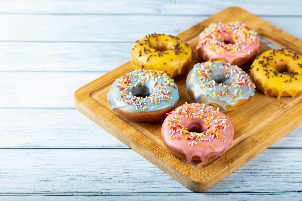 Delicious assorted colorful donuts on the table.