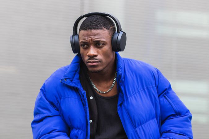 Black man listening to music in city
