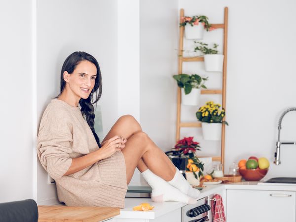 Smiling woman sitting on counter
