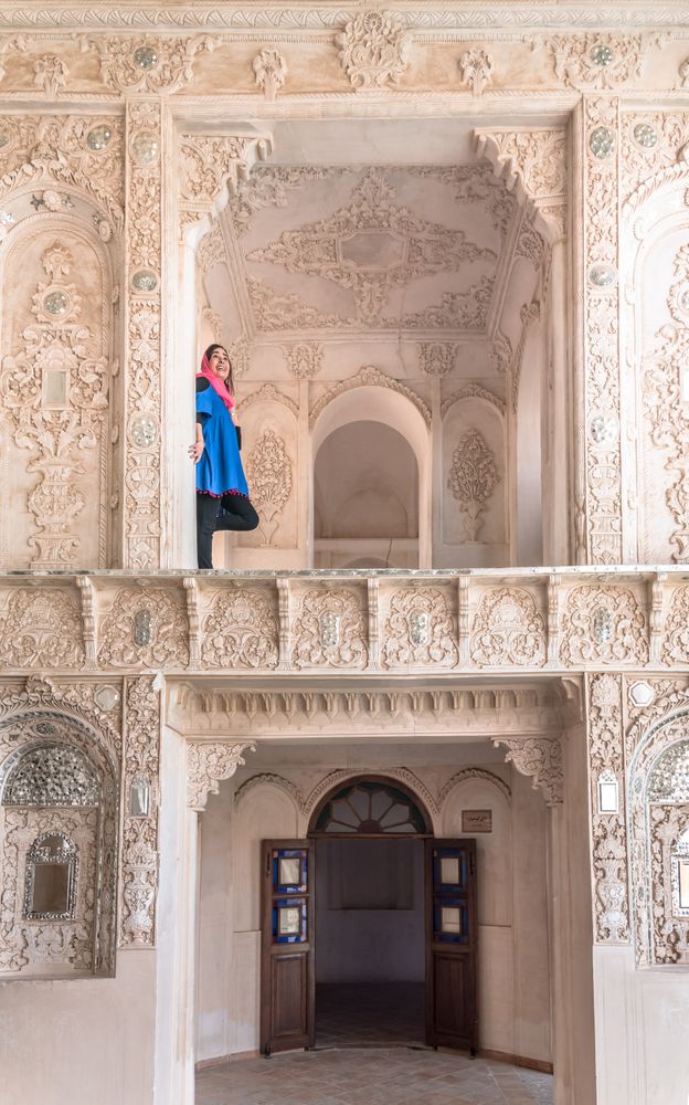 Woman standing on terrace of traditional oriental mosque