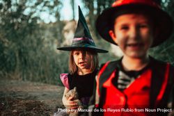 Two siblings in the forest dressed in halloween costumes 5Qyy95