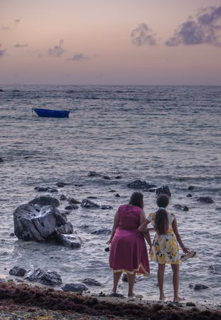 Rearview of two woman looking out a the Indian Ocean